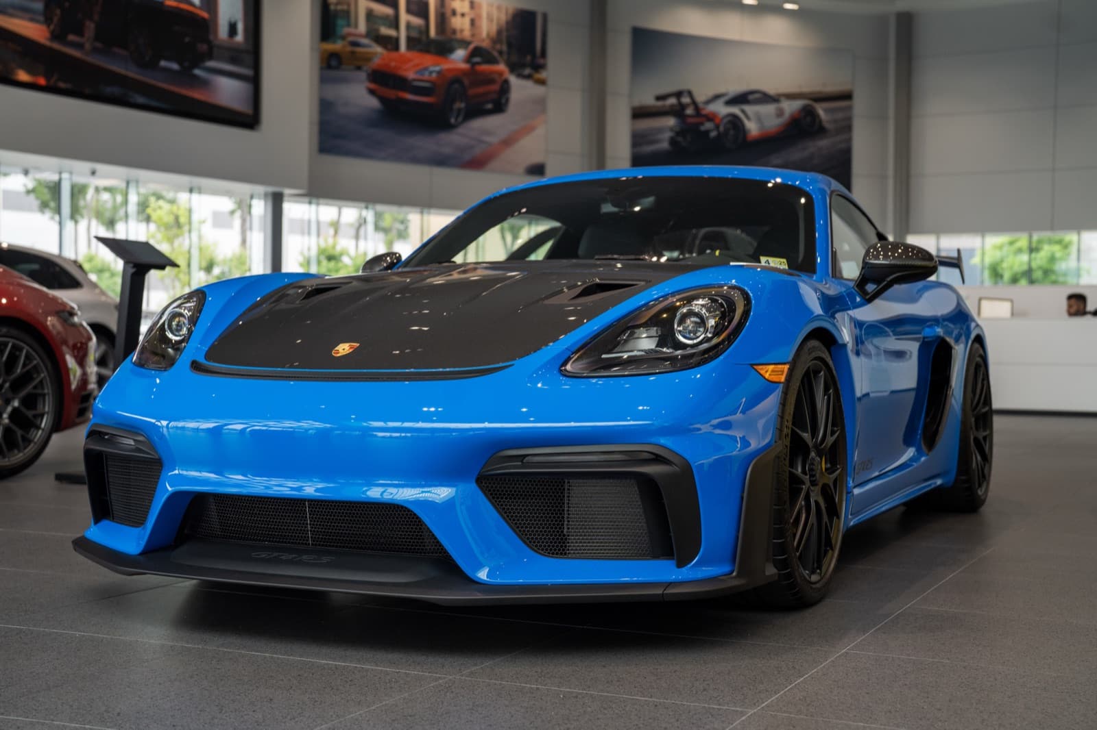 Blue Porsche Cayman GT4 RS in showroom